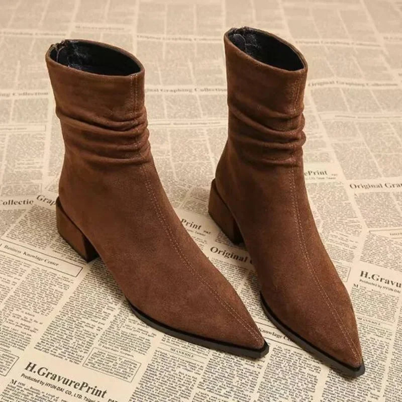 Brown suede pointed-toe ankle boots with block heel on newspaper background, Rovelli fashion