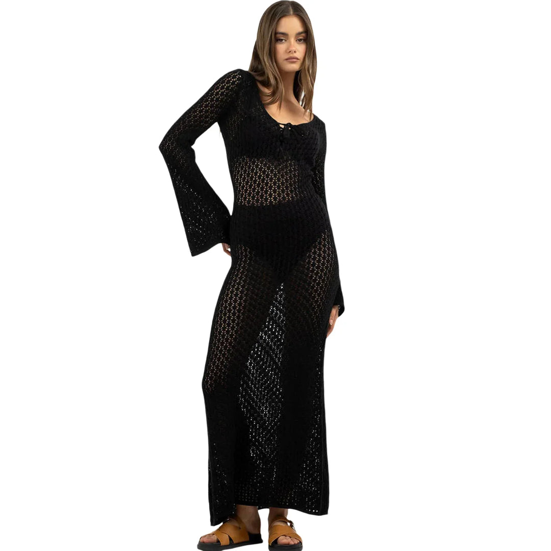 Woman wearing a black crochet long-sleeve maxi dress with sandals from Rovelli