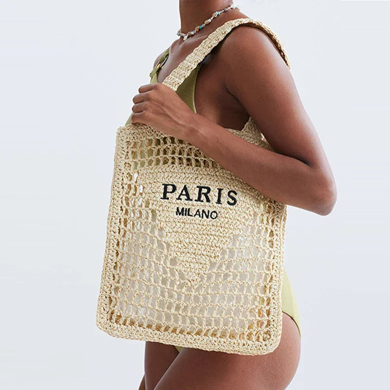 Woman with woven straw tote bag featuring 'PARIS MILANO' text, summer fashion by Rovelli