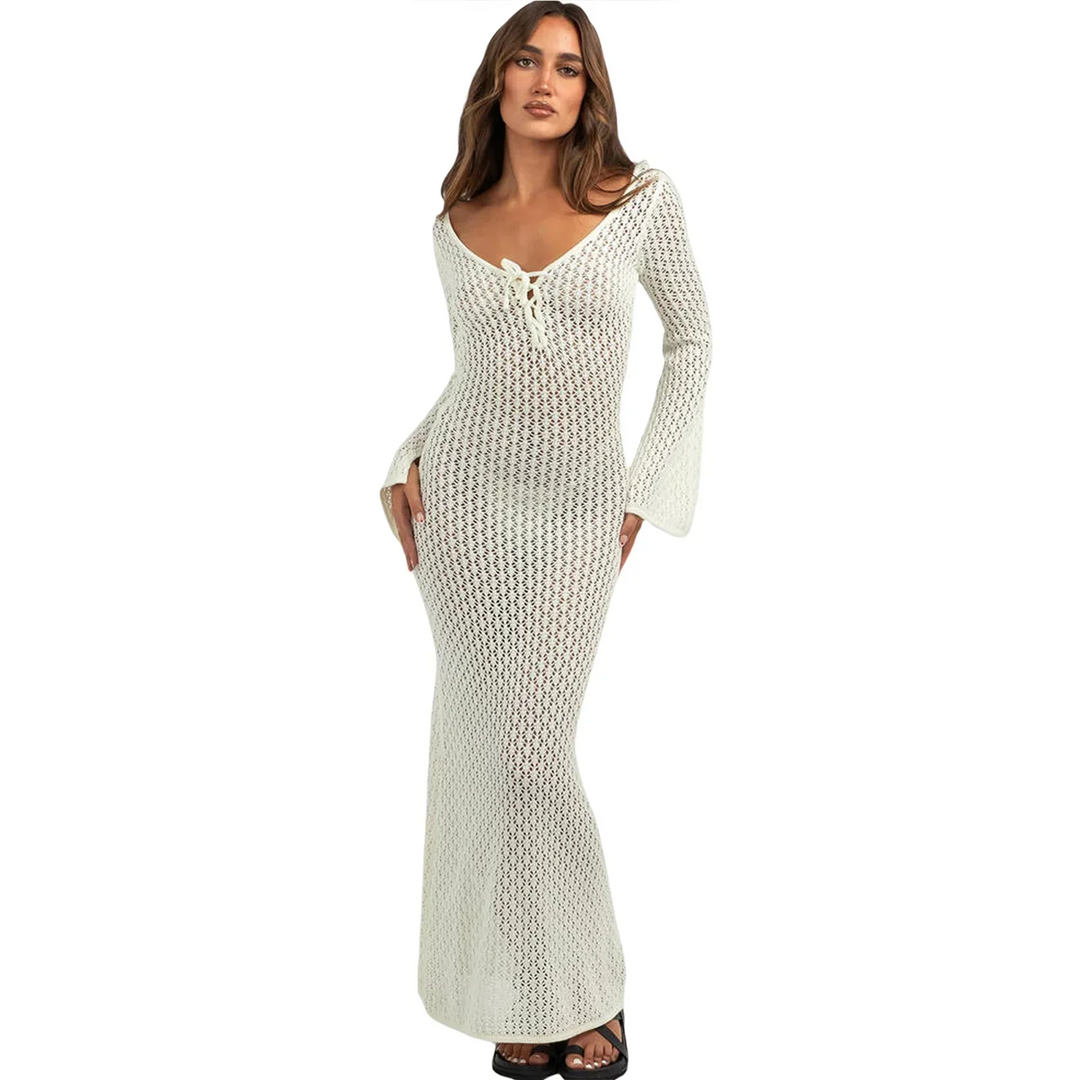 Woman wearing long white crochet knit dress with flared sleeves from Rovelli
