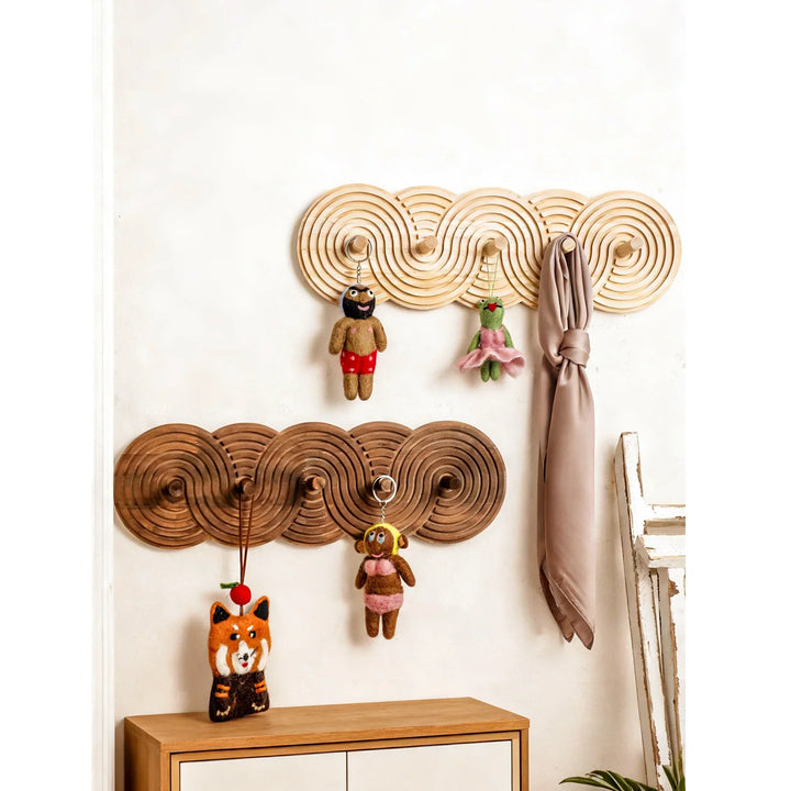 Rovelli decorative wooden wall hooks with plush toys and scarf in modern home entryway