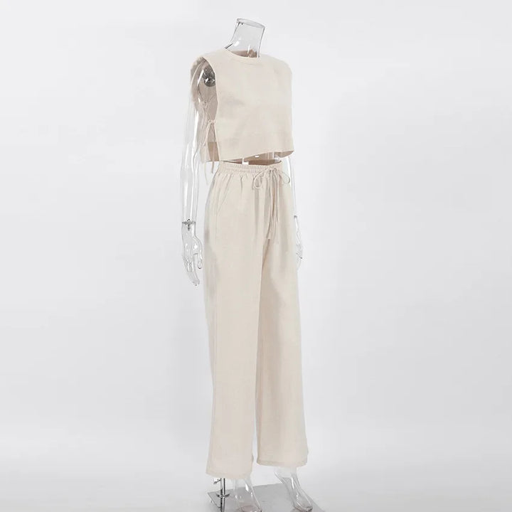 A clear mannequin is dressed in a sleeveless cropped top and matching high-waisted wide-leg pants in a Belgian Linen Blend, displayed against a plain white background.