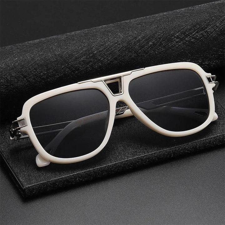 White-framed vintage sunglasses with dark lenses rest on a black textured case against a dark background, exuding classic aviator style and timeless appeal.