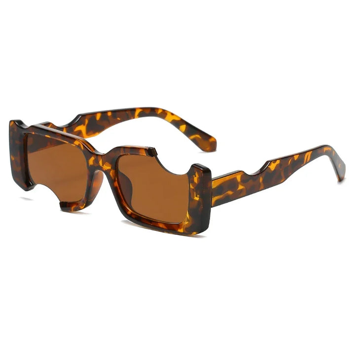 A pair of rectangular sunglasses with brown lenses and a bold, tortoiseshell-patterned frame featuring unique, geometric frames and angular cutout designs along the top and sides—a standout accessory for street style.