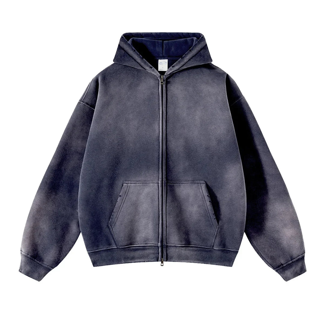 A faded black zip-up hoodie with a hood, front pouch pockets, and a relaxed, oversized fit crafted from thickened fabric, displayed on a white background.