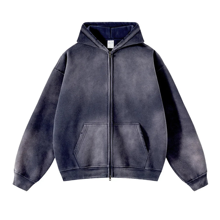 A faded black zip-up hoodie with a hood, front pouch pockets, and a relaxed, oversized fit crafted from thickened fabric, displayed on a white background.