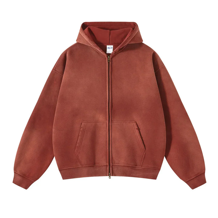 A brown zip-up hoodie crafted from thickened fabric, featuring a front pocket and a hood in a relaxed fit, laid flat on a white background.