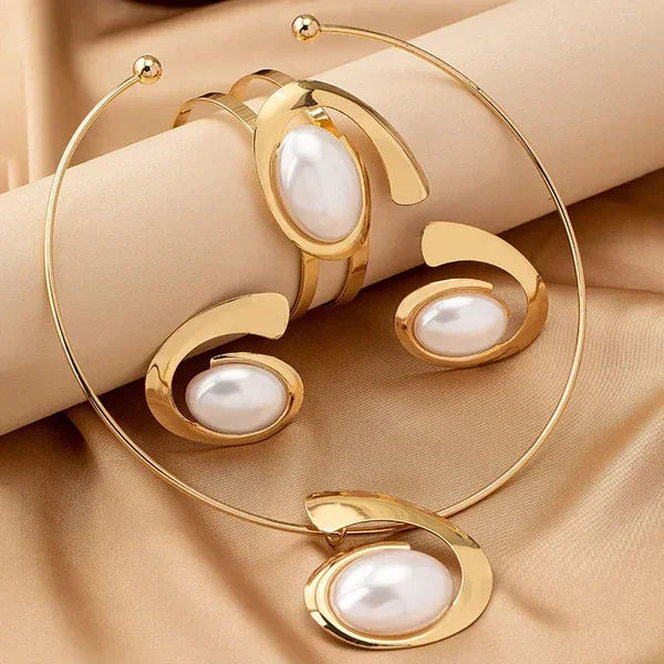 Rovelli gold jewelry set with pearl accents on satin fabric background
