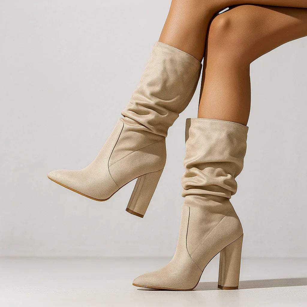 Beige slouchy suede boots with block heels from Rovelli, worn indoors, fashion footwear.