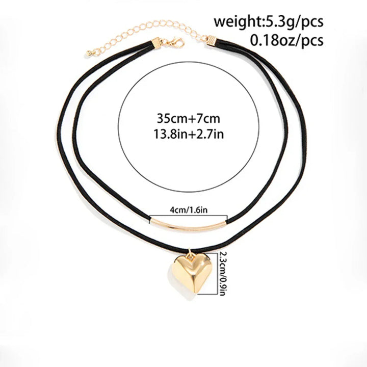 Double black cord velvet choker with a vintage heart pendant and a gold bar charm. Adjustable choker length: 35 cm plus 7 cm extension. Heart is 2.3 cm tall. Total weight: 5.3g (0.18oz).