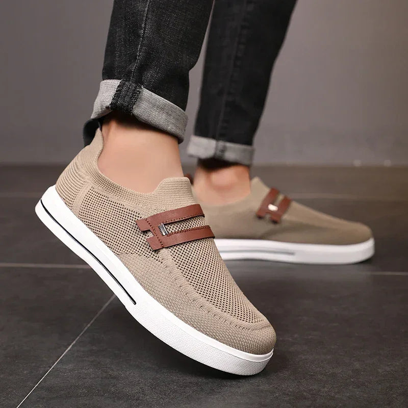 Rovelli beige mesh slip-on sneakers with brown strap, worn with rolled-up jeans on tile floor
