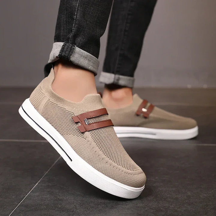 Rovelli beige mesh slip-on sneakers with brown strap, worn with rolled-up jeans on tile floor