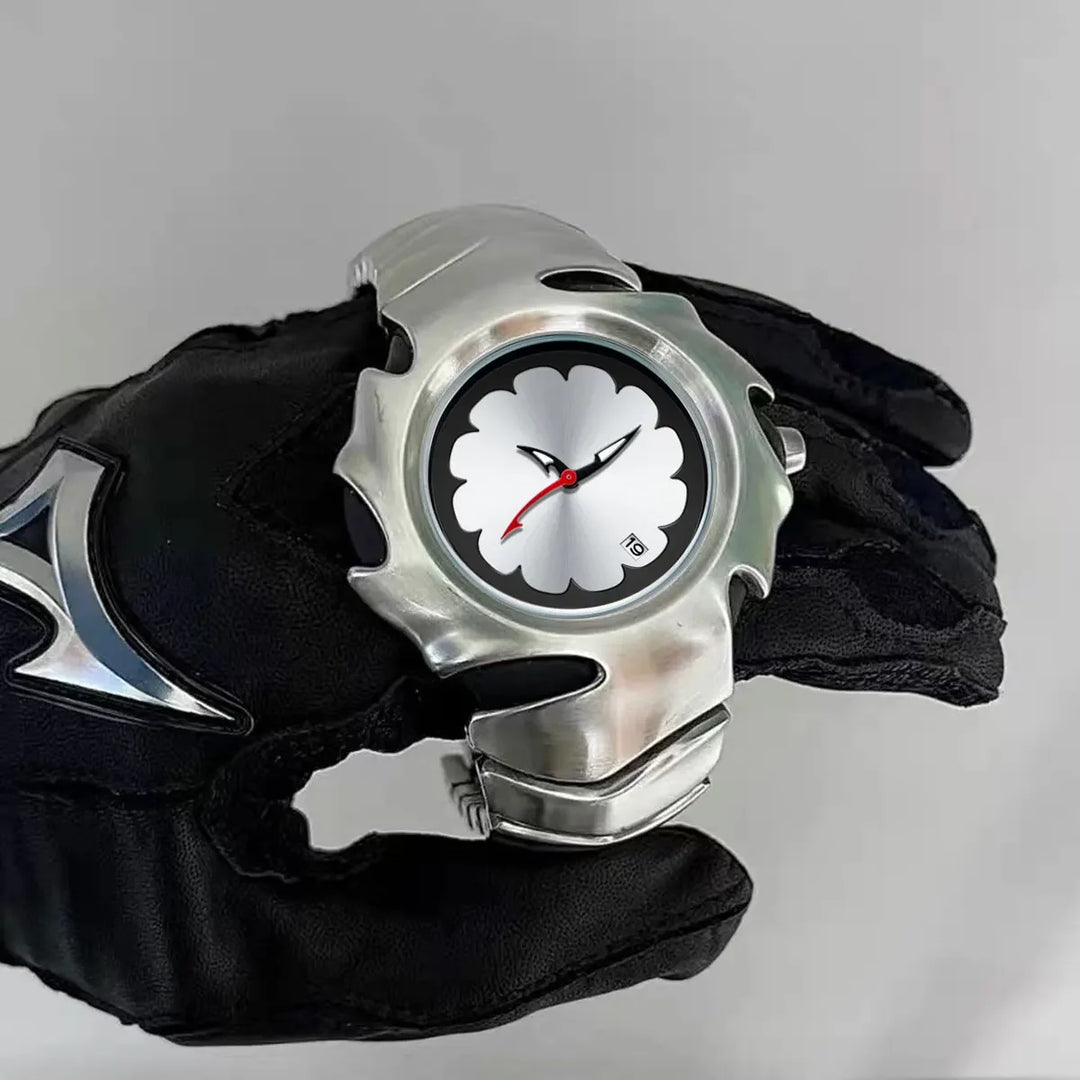 A gloved hand holds a stainless steel watch with a unique, jagged metal bezel and a white clover-shaped pattern on the dial. The scratch-resistant piece features black hour and minute hands, a red second hand, and a small date window.