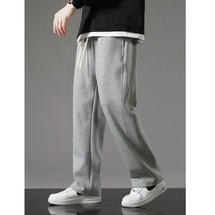 Rovelli grey sweatpants for men with drawstring waist, paired with white sneakers