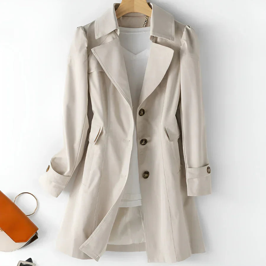 Beige trench coat with buttons from Rovelli, displayed on a hanger, stylish outerwear