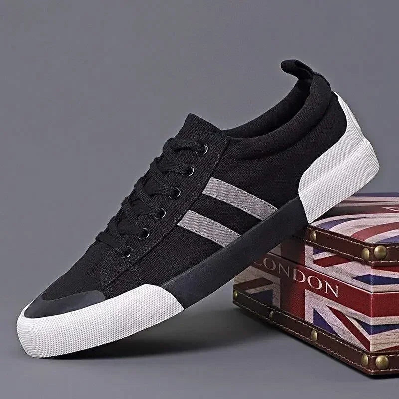 Rovelli black canvas sneaker with white sole and gray stripes on London-inspired box