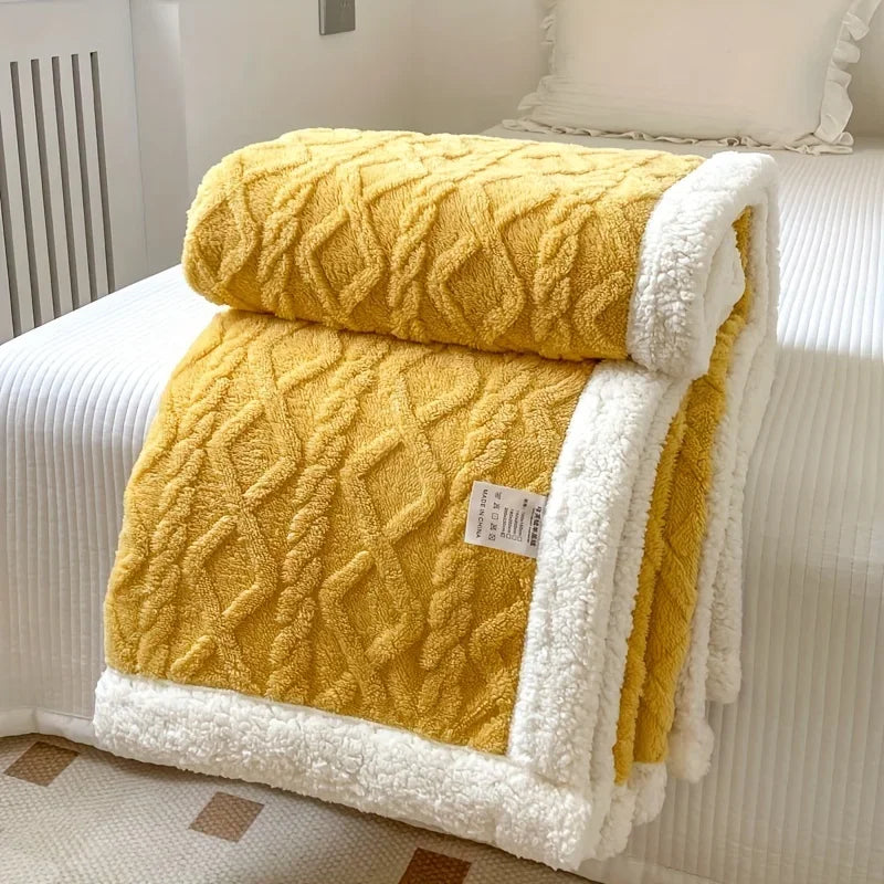 Rovelli yellow sherpa blanket with white trim on a neatly made bed