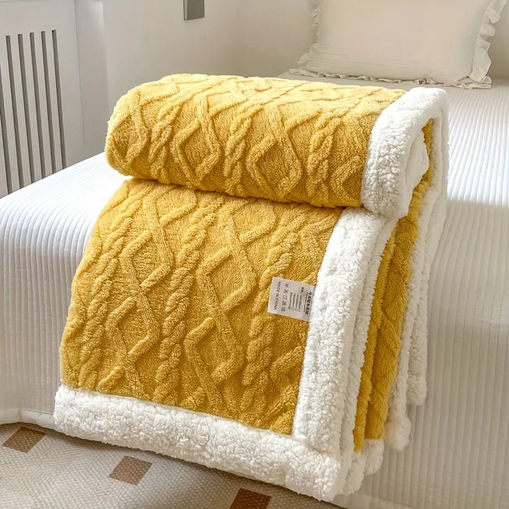 Rovelli yellow sherpa blanket with white trim on a neatly made bed