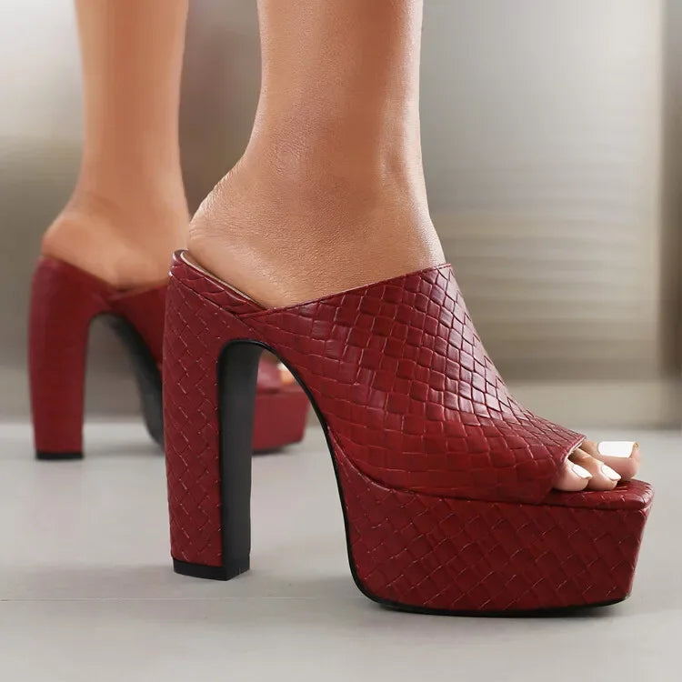 Woman wearing Rovelli red woven platform high heel mules on a light floor