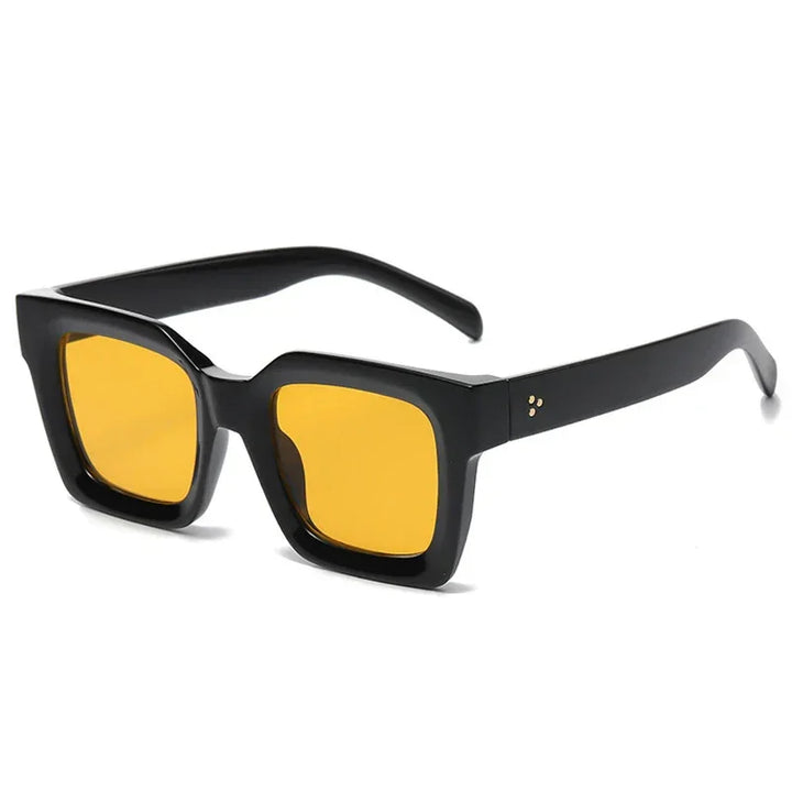 Black square-framed sunglasses with bold, thick acetate frames and yellow tinted lenses, offering UV protection. Shown on a white background.