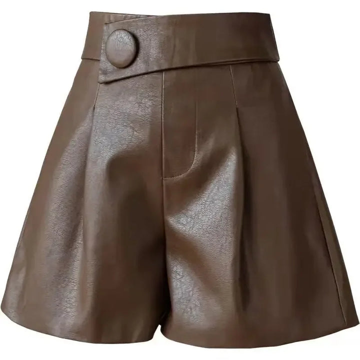 High-waisted brown calfskin leather shorts with a wide waistband, large round button detail on the left side, pleats in front, and a slightly flared leg.