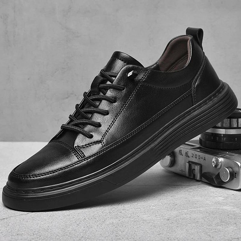 A black genuine leather sneaker with black laces is propped against a vintage camera on a light surface, with a textured gray background. The shoe features a thick sole, minimal stitching details, and comfortable RunForm insoles.