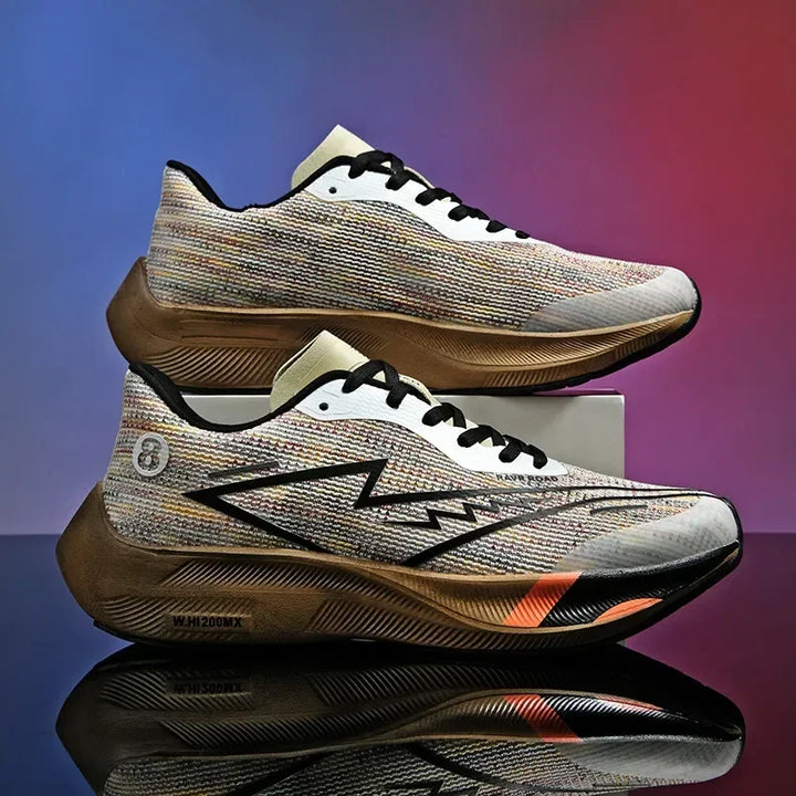 A pair of multicolored running shoes with black laces and zigzag patterns on the side, featuring lightweight construction, displayed against a gradient purple and red background, with one shoe stacked on top of the other.