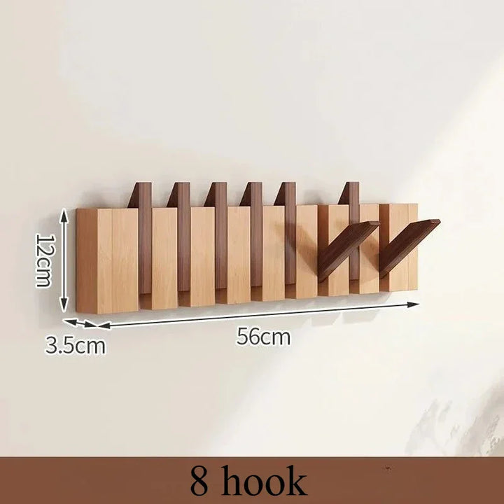 Rovelli modern wooden wall-mounted coat rack with 8 foldable hooks, 56cm wide, 12cm high.