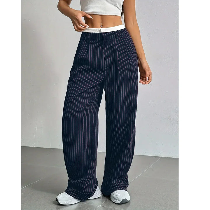 Woman wearing navy pinstripe wide-leg pants and white crop top, Rovelli fashion