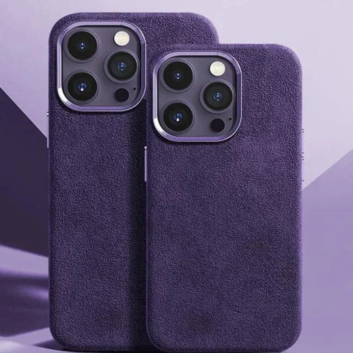 Two smartphones with triple-lens cameras are shown side by side, each in a purple alcantara phone case with a suede finish, set against a purple geometric background.