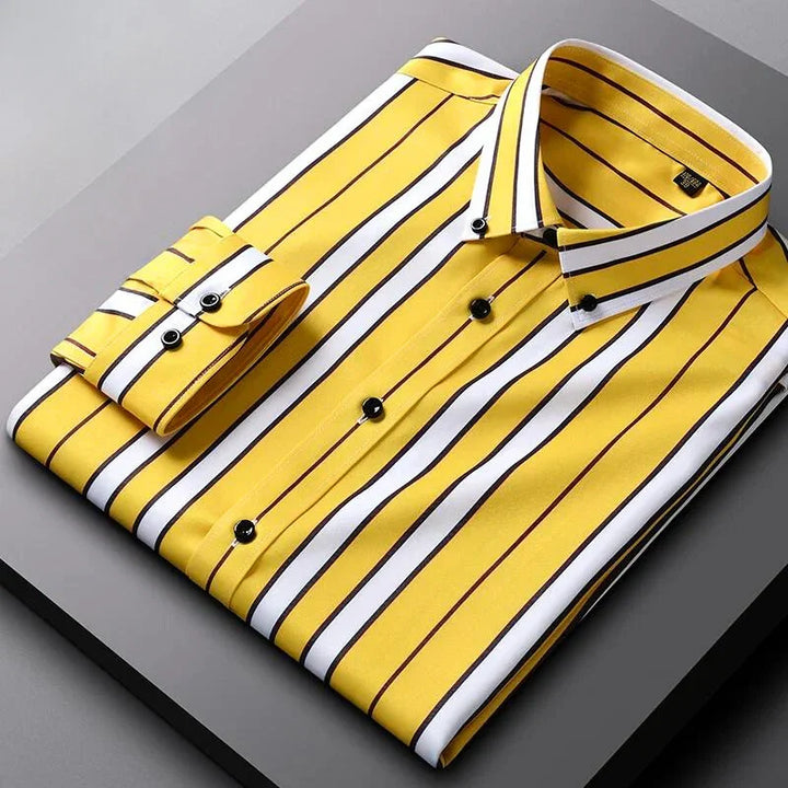 A neatly folded Hamilton Executive Classic Fit Shirt in yellow with black and white vertical stripes, black buttons, and a buttoned cuff, crafted from premium fabric and displayed on a gray surface.