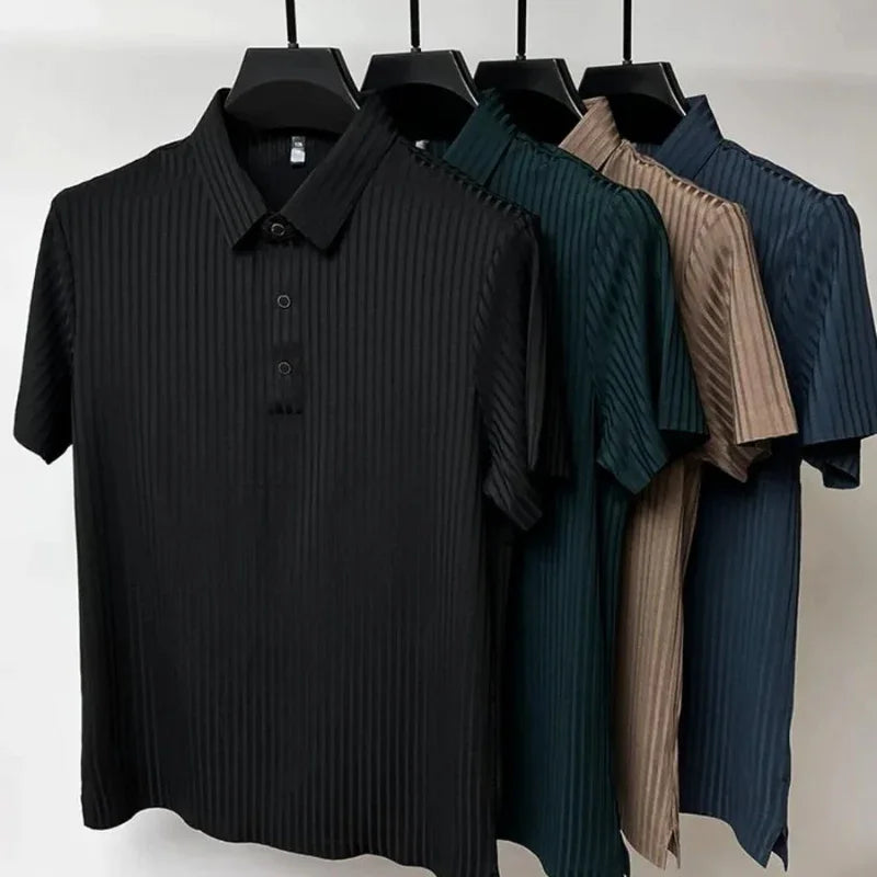 Four short-sleeved, collared shirts with vertical stripes and a classic polo design hang on black hangers. The shirts, in black, dark green, beige, and blue, are displayed against a plain white background.