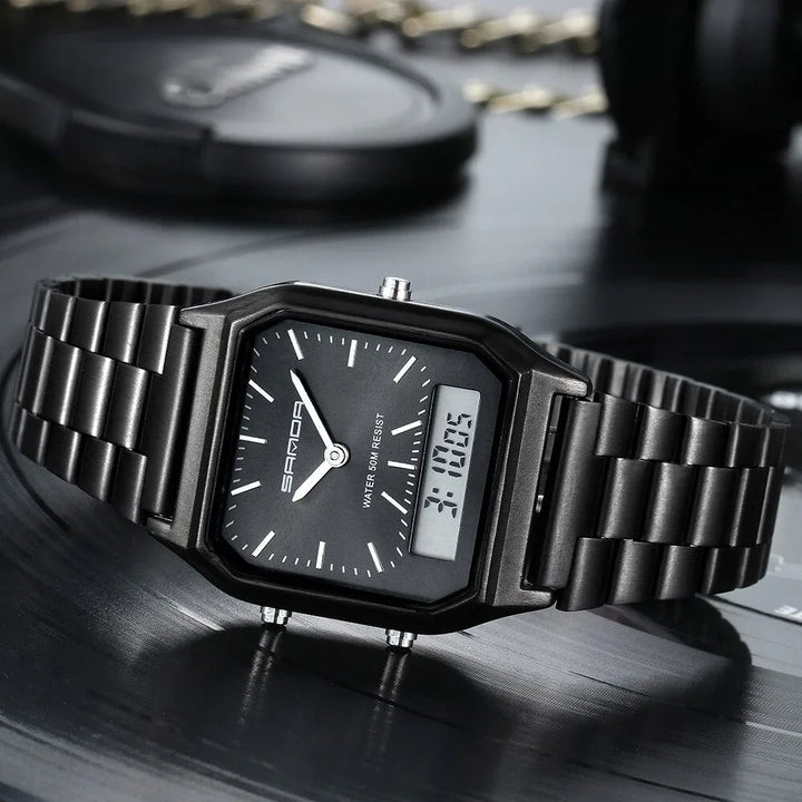 A black Luxury G Style dual display wristwatch with both analog and digital time is shown resting on a dark, reflective surface. White hour markers and hands complement the digital readout, displaying 3:10:05.