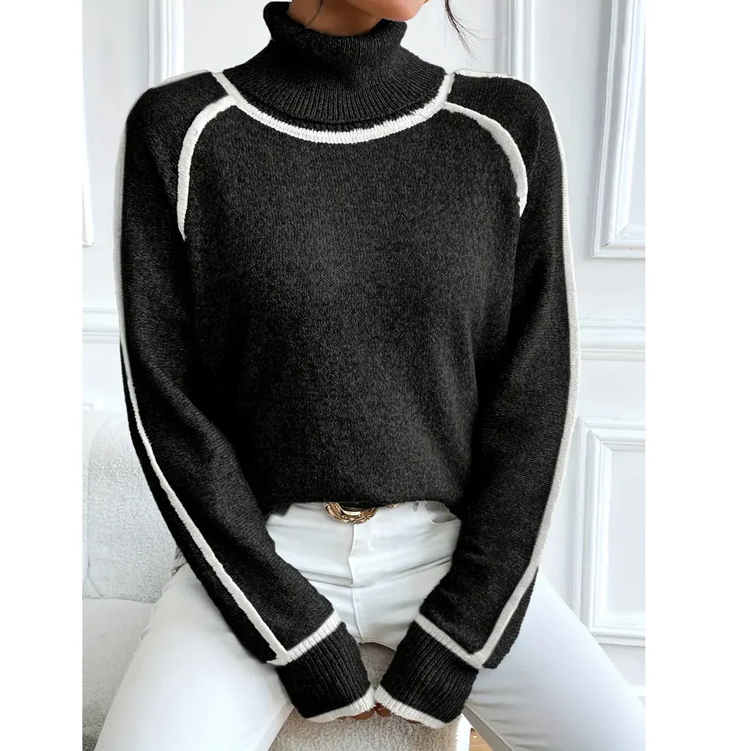 Woman wearing black turtleneck sweater with white trim and white pants, Rovelli fashion