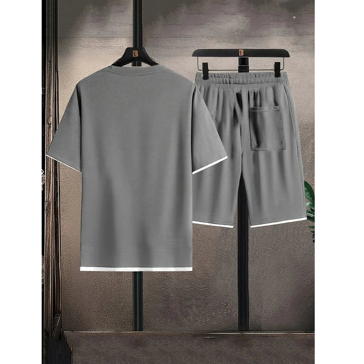 Rovelli gray short sleeve shirt and shorts lounge set with white trim, rear view