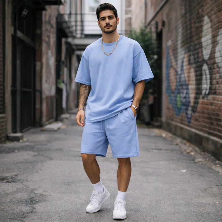 Man wearing light blue oversized t-shirt and shorts set, Rovelli fashion street style