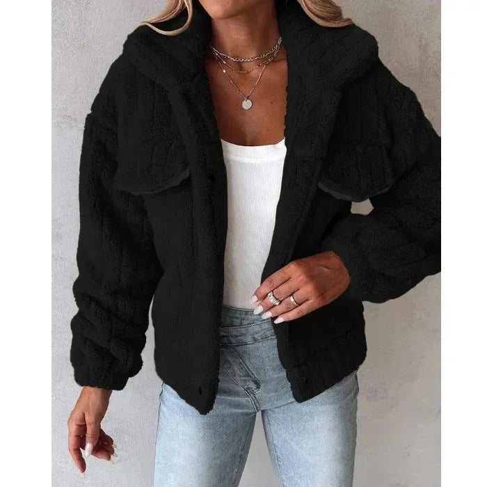 Woman wearing Rovelli black faux fur jacket with white top and light blue jeans