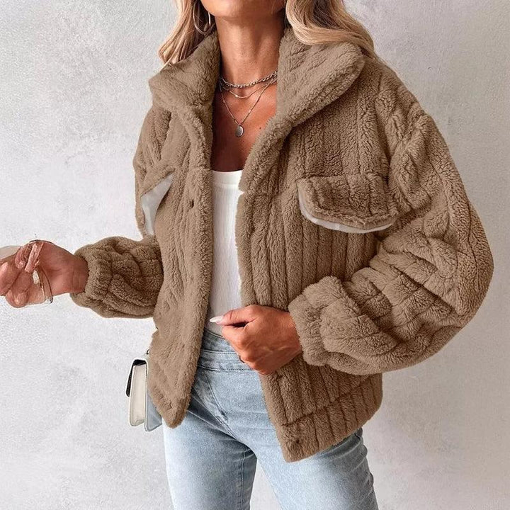 Woman wearing a brown faux fur jacket, white top, jeans; Rovelli fashion casual outerwear
