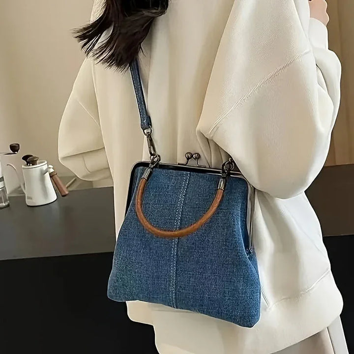 Woman wearing a white sweater with a retro denim shoulder bag from Rovelli