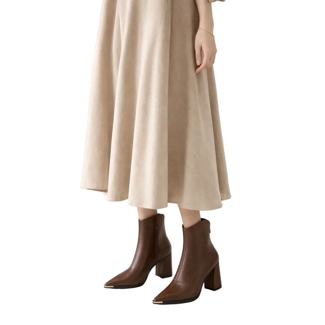 Rovelli model in beige midi skirt and brown leather ankle boots, fashion style