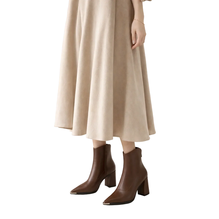 Rovelli model in beige midi skirt and brown leather ankle boots, fashion style