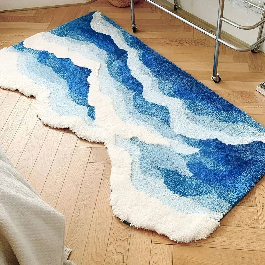 Blue and white abstract area rug on wooden floor, modern decor from Rovelli