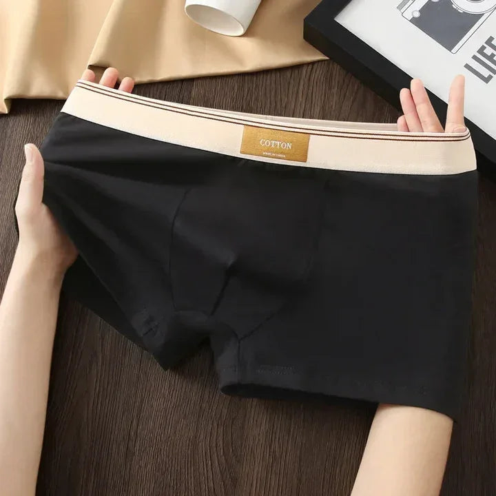 Rovelli men's black cotton boxer briefs with beige waistband displayed on table