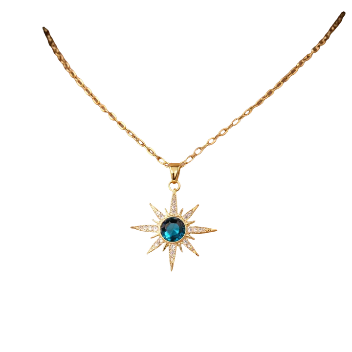 Rovelli gold starburst necklace with blue gemstone pendant on black background