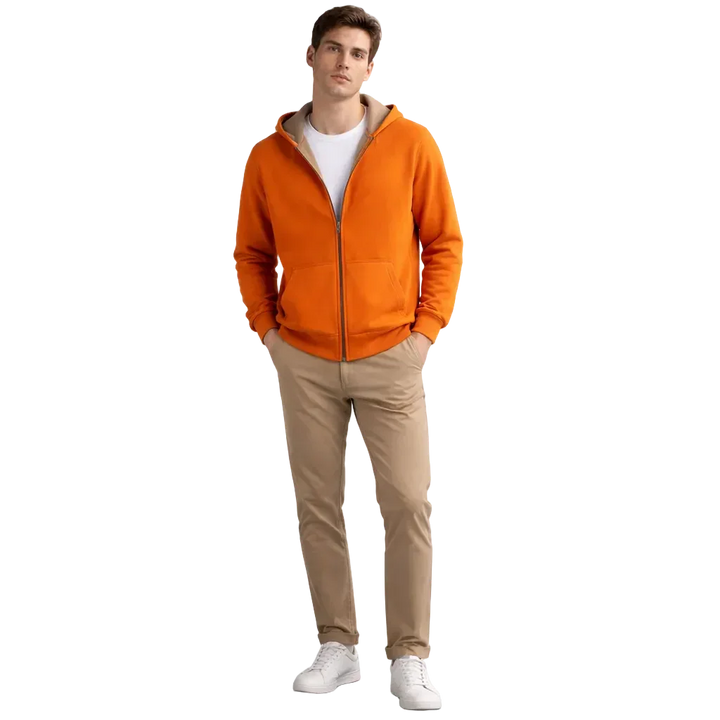 Man wearing orange zip hoodie, beige pants, white sneakers, Rovelli casual menswear