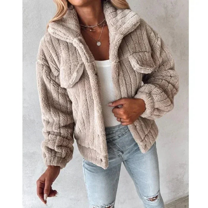 Woman wearing Rovelli gray faux fur jacket with front pockets and light blue jeans