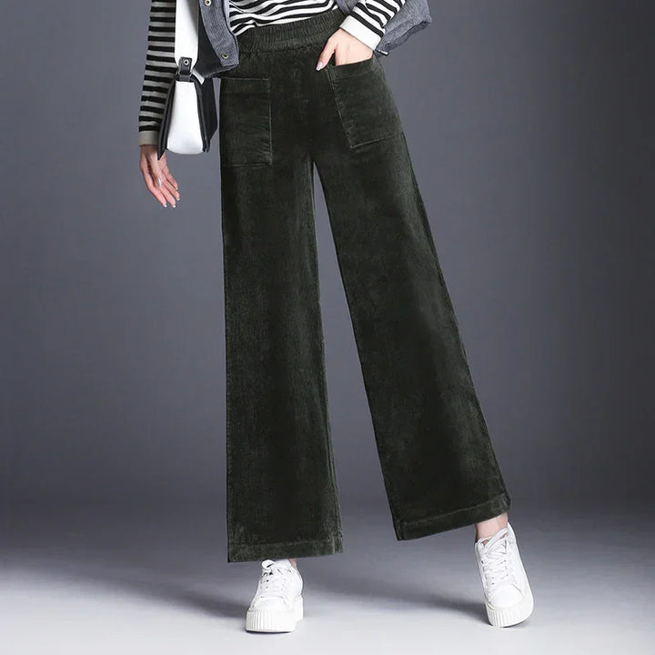 Woman wearing wide-leg dark green corduroy pants from Rovelli, casual fashion style