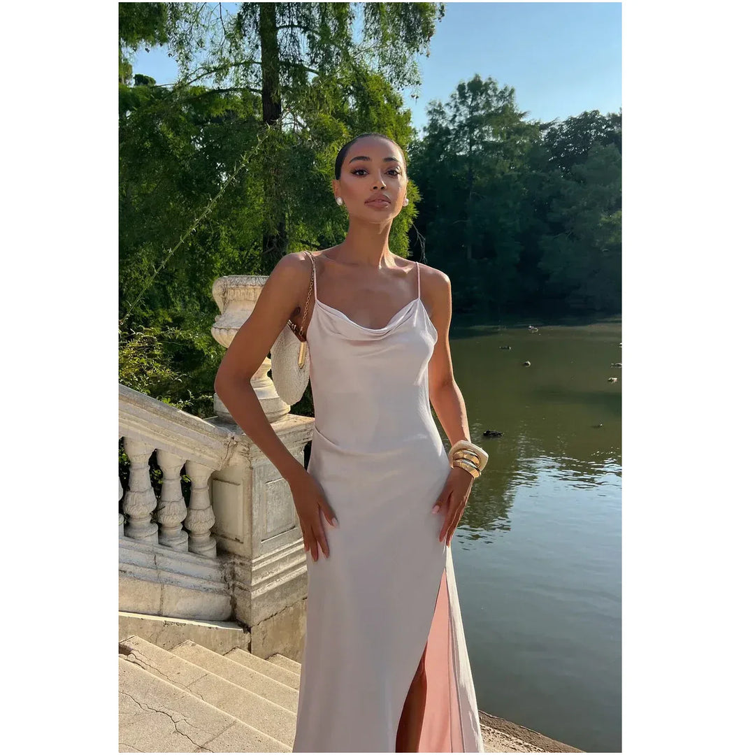 Woman in satin slip dress by water, elegant outdoor fashion, Rovelli style clothing