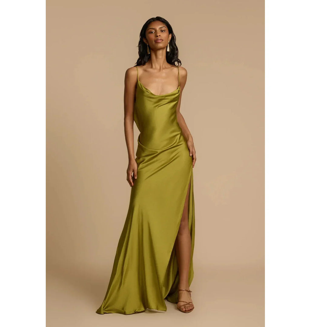 Woman modeling olive green satin slip dress with thigh-high slit, Rovelli fashion.
