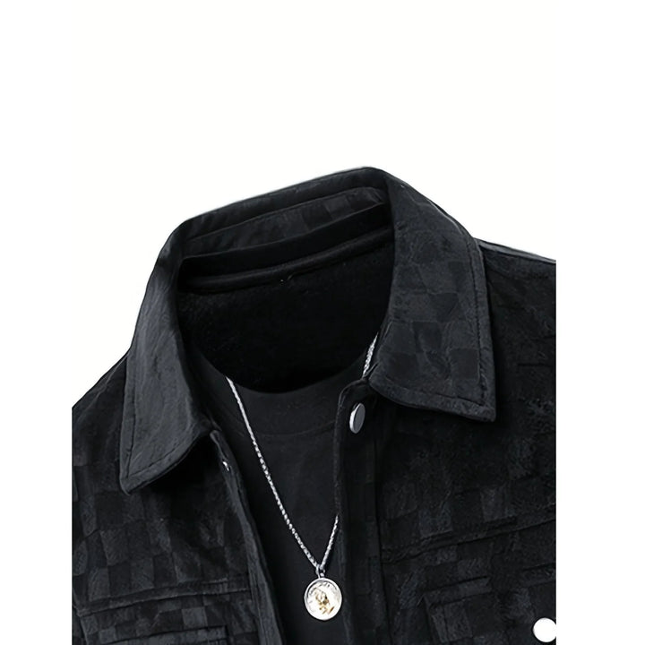 Rovelli black checkered jacket with collar, black shirt, and silver pendant necklace